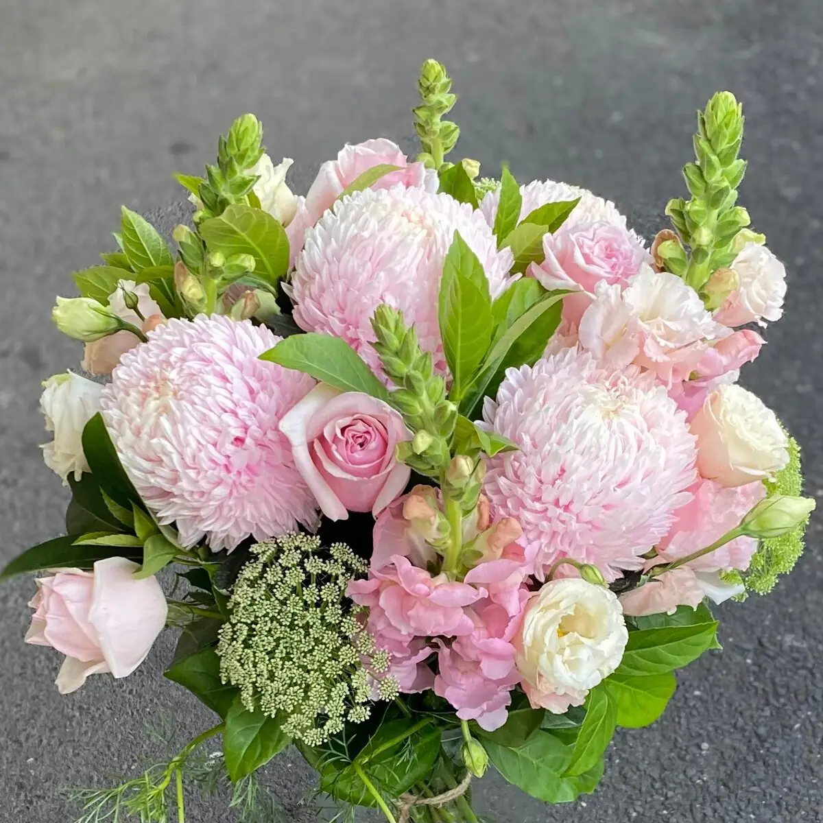 Hand-tied bouquet of soft pink seasonal blooms