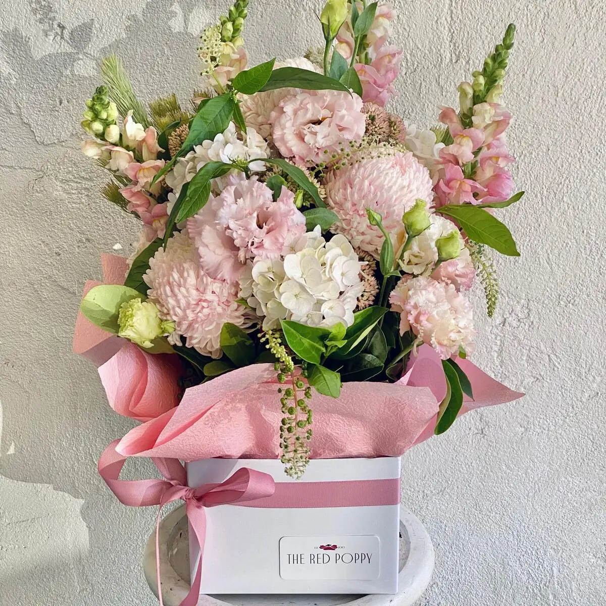 Boxed arrangement of soft pastel pink blooms in The Red Poppy gift box