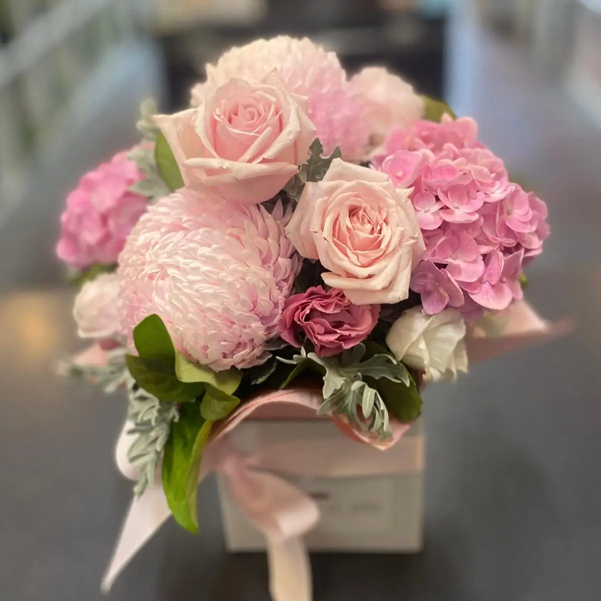 Petite boxed arrangement of soft pink roses and hydrangea